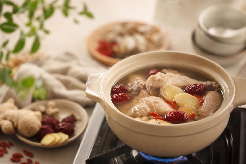Gentle herbal soup with red dates and ginger simmering safely for pregnancy
